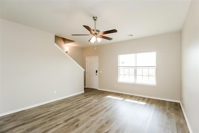 Empty room featuring ceiling fan and hardwood / wo