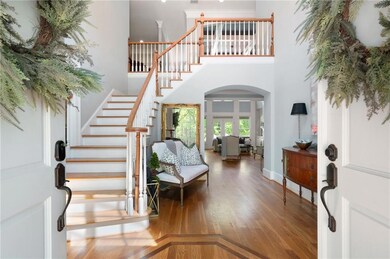 Step inside to a stunning two-story foyer featurin