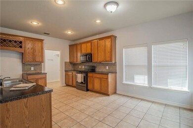 Kitchen features new range and microwave. Laundry 