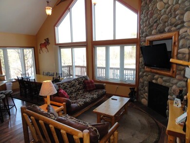 Great room with natural gas stone fireplace. Fully