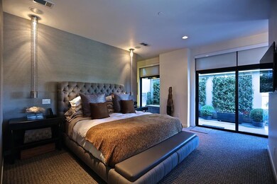 Bedroom featuring dark carpet and access to exteri