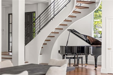 Staircase featuring wood finished floors