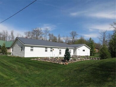 View of backyard and home.  Nicely landscaped corn