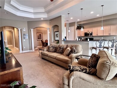 Spacious open-concept living with waterfront views! This beautifully maintained second-floor home offers an inviting great room with elegant tray ceilings, architectural columns, and abundant natural light. Enjoy relaxing or entertaining in style with open sightlines from the living area to the kitchen and beyond. The kitchen features wood cabinetry, granite counters, and a large breakfast bar. Step inside and take in serene waterfront views from the main living spaces, creating a peaceful backdrop.