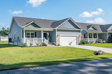View of front facade with a garage, a front lawn, 