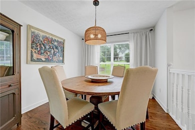 Dining area featuring wood finished floors and a textured ceiling
