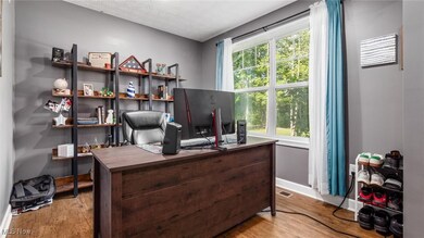 Office area featuring light wood finished floors and a textured ceiling
