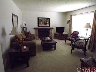 Living Room. Fireplace on far wall, window looks o