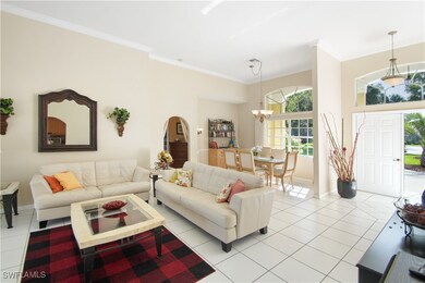 Tiled living room with an inviting chandelier and