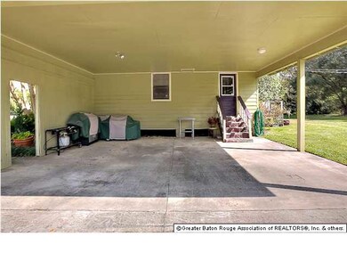 The covered two car carport has tons of room and l