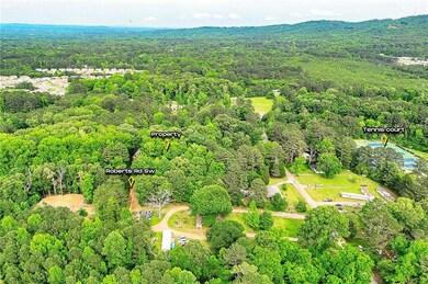 Aerial view of property and surrounding area featuring a heavily wooded area