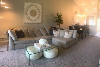 Carpeted living area featuring baseboards, lofted
