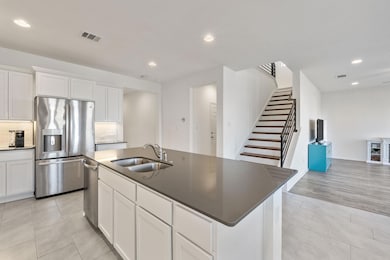 Kitchen featuring visible vents, a sink, tasteful