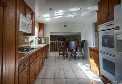 Large kitchen with eating area overlooks the famil