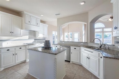 Kitchen featuring stainless steel dishwasher, a si