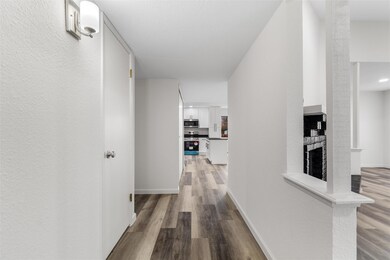 Hall with hardwood / wood-style flooring