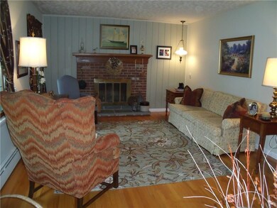 Living room with wood-burning fireplace.