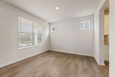 Spare room with light wood finished floors and bas