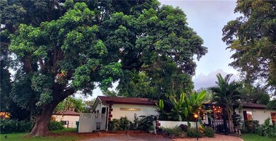 A canvas of trees surround the home.