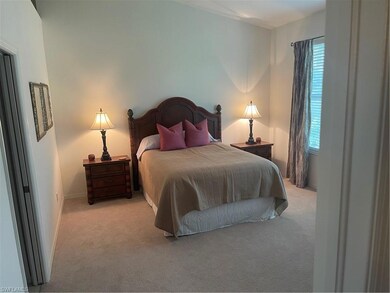 Carpeted bedroom with multiple windows