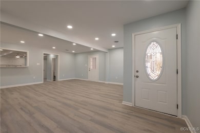 Entryway featuring wood finished floors, recessed