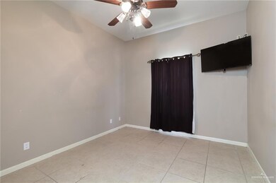 Spare room with ceiling fan and light tile patterned flooring