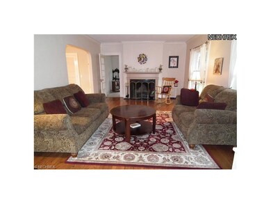 INVITING LIVING ROOM WITH HARDWOOD FLOORS AND FIRE