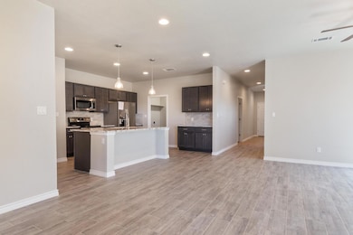 Kitchen featuring stainless steel appliances, ope