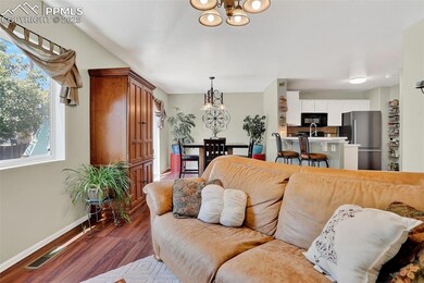 Living area with a chandelier and wood finished floors
