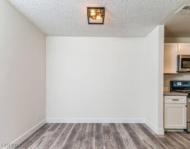 Unfurnished dining area with a textured ceiling, w