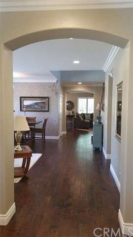 Expansive hallways and rich wood flooring draws yo