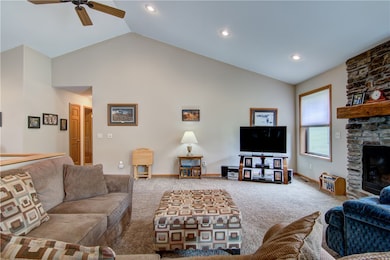 Living Room With Vaulted Ceiling and Gas Stone Fir