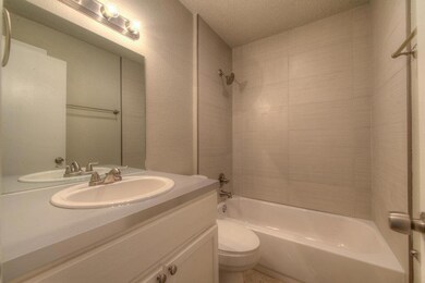 Bathroom featuring vanity, a textured ceiling, an