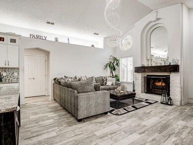 The wood-burning fireplace and hanging chandelier 