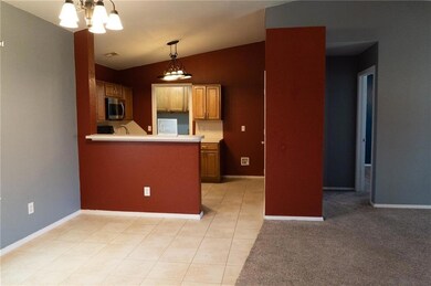 Kitchen with decorative light fixtures, light tile