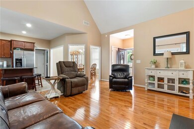 Living room featuring high vaulted ceiling, light 