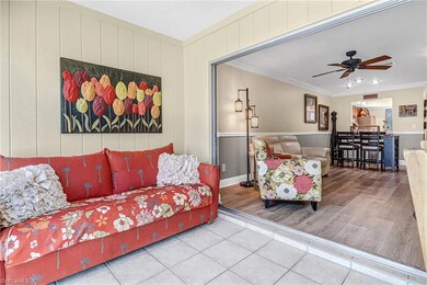 Tiled living room with ceiling fan and ornamental 