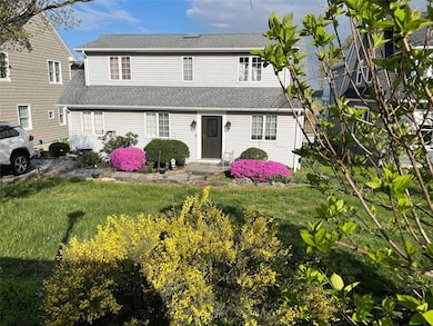 View of front of home featuring a front yard and r