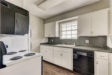 Kitchen with white range/electric cooktop, white c