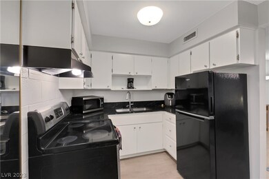 Refinished cabinets and new black granite countert