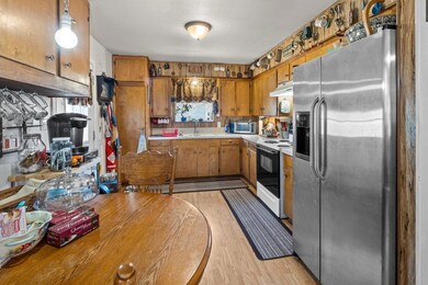 Kitchen with stainless steel fridge, brown cabine