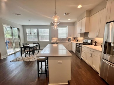 Kitchen featuring stainless steel appliances, dar
