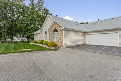 Single story home featuring a front lawn and a gar