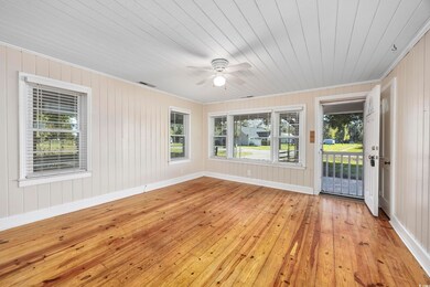 Unfurnished sunroom with ceiling fan and wooden ce