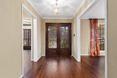 The welcoming double front door is accented by leaded glass and the entry is highlighted by gorgeous hand scraped wood floors.  The wood floors run throughout the living areas of the first floor.