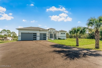 View of front of home with an attached garage, stu