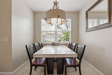 Dining space with baseboards, a notable chandelier