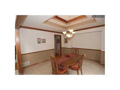 Dining room features a double tray ceiling, crown 