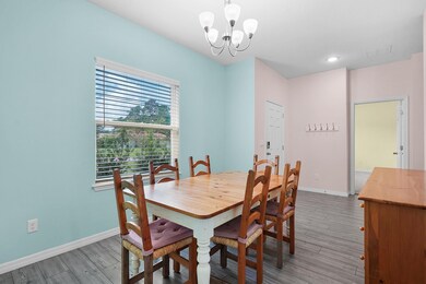 Dining space featuring wood finished floors, a chandelier, and recessed lighting