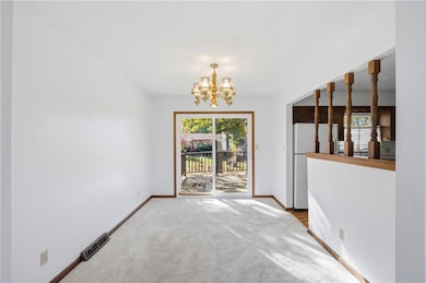 Unfurnished dining area with a chandelier and carpet flooring